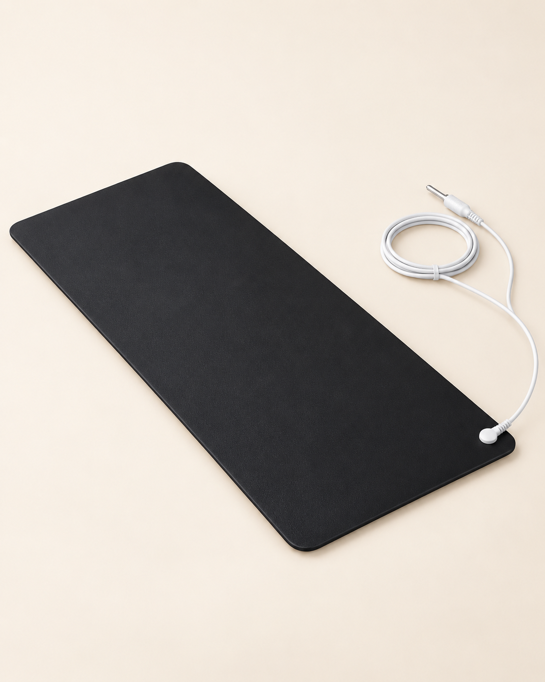 The elongated black Everyday Grounding Mat with its white grounding cord